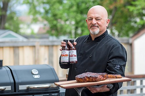 MIKAELA MACKENZIE / WINNIPEG FREE PRESS

Steve Hunt-Lesage, owner Fat Iguana Chef's Kitchen, poses for a portrait with a steak and a couple of his sauces in Winnipeg on Tuesday, May 25, 2021. For Dave Sanderson story.
Winnipeg Free Press 2020.