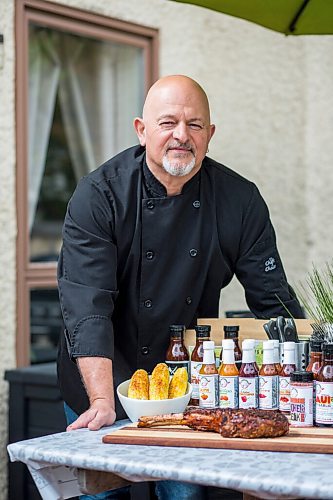 MIKAELA MACKENZIE / WINNIPEG FREE PRESS

Steve Hunt-Lesage, owner Fat Iguana Chef's Kitchen, poses for a portrait with some of his products in Winnipeg on Tuesday, May 25, 2021. For Dave Sanderson story.
Winnipeg Free Press 2020.