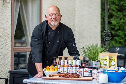 MIKAELA MACKENZIE / WINNIPEG FREE PRESS

Steve Hunt-Lesage, owner Fat Iguana Chef's Kitchen, poses for a portrait with some of his products in Winnipeg on Tuesday, May 25, 2021. For Dave Sanderson story.
Winnipeg Free Press 2020.