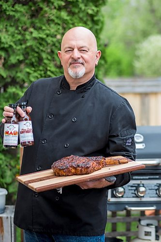 MIKAELA MACKENZIE / WINNIPEG FREE PRESS

Steve Hunt-Lesage, owner Fat Iguana Chef's Kitchen, poses for a portrait with a steak and a couple of his sauces in Winnipeg on Tuesday, May 25, 2021. For Dave Sanderson story.
Winnipeg Free Press 2020.