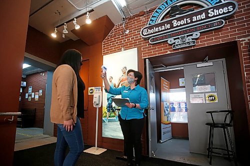 JOHN WOODS / WINNIPEG FREE PRESS
Supervisor Elena Tarnavski, right, tests temperatures and and asks COVID questions at the entrance of Canadian Footwear in Winnipeg Thursday, May 27, 2021. COVID-19 restrictions have been extended. 

Reporter: Durrani