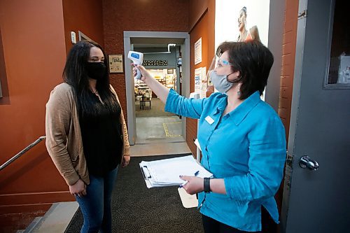 JOHN WOODS / WINNIPEG FREE PRESS
Supervisor Elena Tarnavski, right, tests temperatures and and asks COVID questions at the entrance of Canadian Footwear in Winnipeg Thursday, May 27, 2021. COVID-19 restrictions have been extended. 

Reporter: Durrani