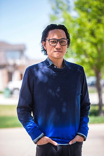 MIKAELA MACKENZIE / WINNIPEG FREE PRESS

Dr. Anthony Battad, who is speaking out about the inequality of the pandemic, poses for a portrait in front of his home in Winnipeg on Friday, May 28, 2021. Battad is a Filipino internal medicine physician who has been working in COVID wards off and on during the pandemic, and he's also involved in outreach efforts through the Chamber of Commerce to engage the Filipino and South Asian communities (on vaccines and public-health messages). He says most of the people he sees admitted to hospital now are lower income folks who have not been able to work from home. For Katie May story.
Winnipeg Free Press 2020.