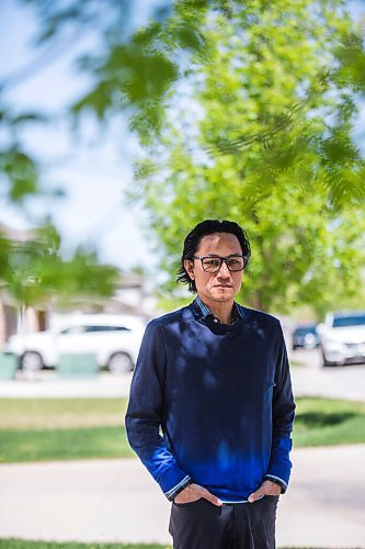 MIKAELA MACKENZIE / WINNIPEG FREE PRESS

Dr. Anthony Battad, who is speaking out about the inequality of the pandemic, poses for a portrait in front of his home in Winnipeg on Friday, May 28, 2021. Battad is a Filipino internal medicine physician who has been working in COVID wards off and on during the pandemic, and he's also involved in outreach efforts through the Chamber of Commerce to engage the Filipino and South Asian communities (on vaccines and public-health messages). He says most of the people he sees admitted to hospital now are lower income folks who have not been able to work from home. For Katie May story.
Winnipeg Free Press 2020.