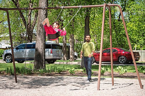 MIKE SUDOMA / WINNIPEG FREE PRESS  
Diego Loukota pushes his daughter Remedios on the swings in Peanut Park in River Heights Friday afternoon
May 28, 2021