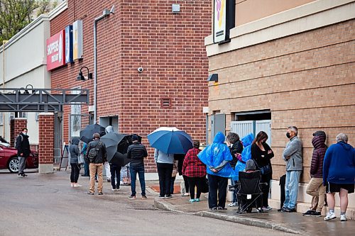 Daniel Crump / Winnipeg Free Press. People lineup outside the Osborne Shoppers Drug Mart location waiting to receive AstraZeneca vaccines. Second doses are available for people age 40 and up. May 29, 2021.