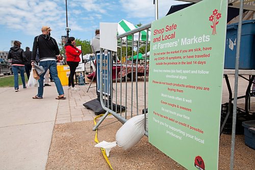 Daniel Crump / Winnipeg Free Press. A sign reminds people hoping to get into the St. Norbert Farmers Market of safety protocols. The Market is able to stay open at reduced capacity during the current public health orders. May 29, 2021.