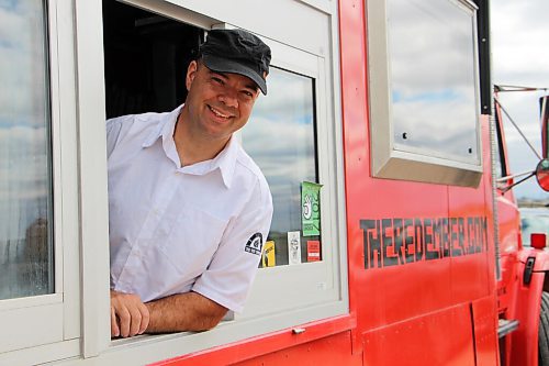 Canstar Community News Steffen Zinn pops out of The Red Ember food truck on May 26. Zinn is selling the truck this fall. (GABRIELLE PICHÉ/CANSTAR COMMUNITY NEWS/HEADLINER)