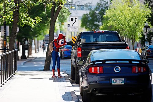 JOHN WOODS / WINNIPEG FREE PRESS
Winnipegs Spider-Man checks his reflection in a truck window in the Exchange District in Winnipeg Monday, May 31, 2021. Spider-Man conducts neighbourhood patrols on his bicycle.

Reporter: Sanderson