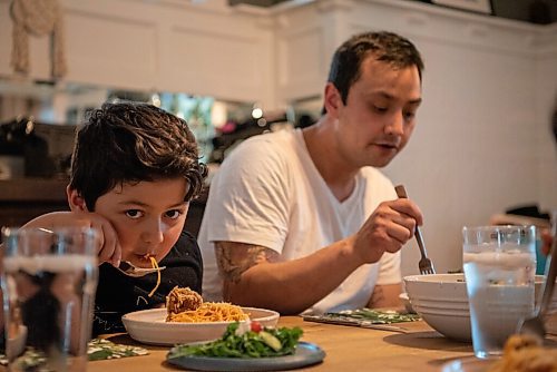 ALEX LUPUL / WINNIPEG FREE PRESS  

Kyle Lew and his son Charlie, sit down for a family meal in the family's home in Winnipeg Wednesday, June 2, 2021. The homemade family-friendly ricotta meatball dish Kyle and Kristen prepared is a favourite of their children.

Reporter: Eva Wasney