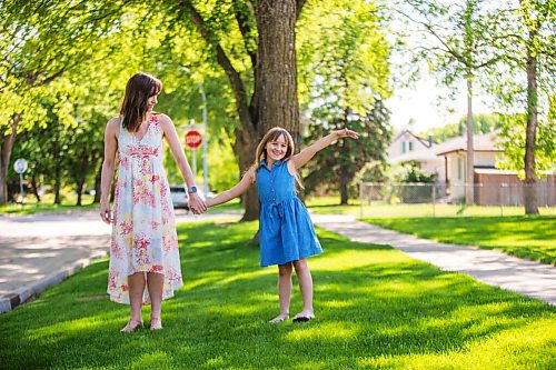 MIKAELA MACKENZIE / WINNIPEG FREE PRESS

Renée Cable and her daughter, Madeleine Linner (eight) pose for a portrait in front of their house in Winnipeg on Thursday, June 3, 2021. Cable said her daughter teared up when she heard she would not be returning to school full-time this year. For Maggie story.
Winnipeg Free Press 2021.