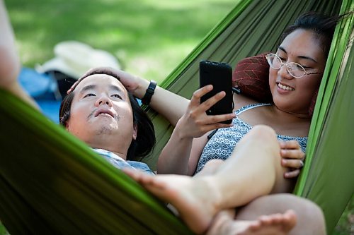 Daniel Crump / Winnipeg Free Press. Bao Nguyen and Sheera Maano relax in a hammock in St. Vital park as they try to escape the record breaking heatwave. Temperatures have soared all across southern Manitoba on Friday and Saturday and multiple weather records have been broken. June 5, 2021.