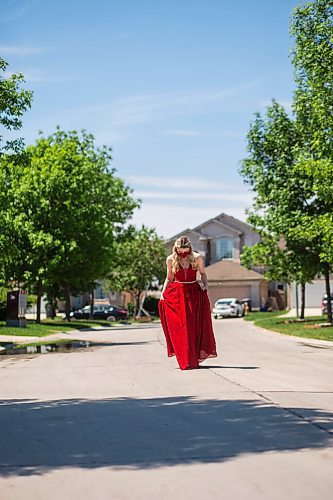 MIKAELA MACKENZIE / WINNIPEG FREE PRESS

Alexa Craig, who is graduating this year, poses for a portrait in her grad dress on her street in Winnipeg on Monday, June 7, 2021. She's one of thousands of Winnipeg grads who said yes to the dress, only for public health to say no to gatherings. For Jen Zoratti story.
Winnipeg Free Press 2021.