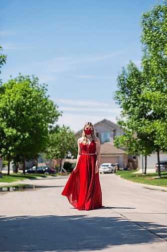 MIKAELA MACKENZIE / WINNIPEG FREE PRESS

Alexa Craig, who is graduating this year, poses for a portrait in her grad dress on her street in Winnipeg on Monday, June 7, 2021. She's one of thousands of Winnipeg grads who said yes to the dress, only for public health to say no to gatherings. For Jen Zoratti story.
Winnipeg Free Press 2021.