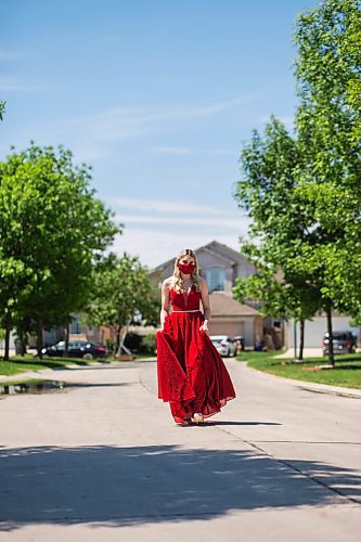 MIKAELA MACKENZIE / WINNIPEG FREE PRESS

Alexa Craig, who is graduating this year, poses for a portrait in her grad dress on her street in Winnipeg on Monday, June 7, 2021. She's one of thousands of Winnipeg grads who said yes to the dress, only for public health to say no to gatherings. For Jen Zoratti story.
Winnipeg Free Press 2021.