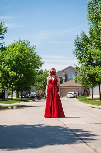 MIKAELA MACKENZIE / WINNIPEG FREE PRESS

Alexa Craig, who is graduating this year, poses for a portrait in her grad dress on her street in Winnipeg on Monday, June 7, 2021. She's one of thousands of Winnipeg grads who said yes to the dress, only for public health to say no to gatherings. For Jen Zoratti story.
Winnipeg Free Press 2021.