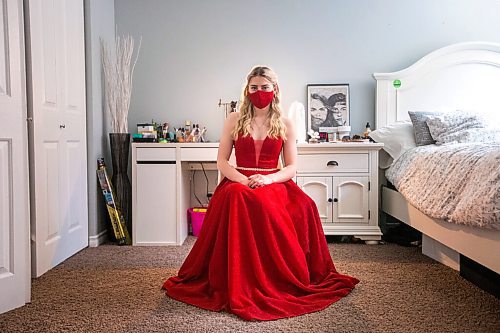 MIKAELA MACKENZIE / WINNIPEG FREE PRESS

Alexa Craig, who is graduating this year, poses for a portrait in her grad dress in her room in Winnipeg on Monday, June 7, 2021. She's one of thousands of Winnipeg grads who said yes to the dress, only for public health to say no to gatherings. For Jen Zoratti story.
Winnipeg Free Press 2021.