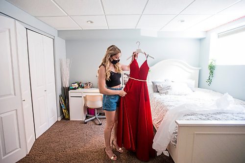 MIKAELA MACKENZIE / WINNIPEG FREE PRESS

Alexa Craig, who is graduating this year, poses for a portrait with her grad dress in her room in Winnipeg on Monday, June 7, 2021. She's one of thousands of Winnipeg grads who said yes to the dress, only for public health to say no to gatherings. For Jen Zoratti story.
Winnipeg Free Press 2021.