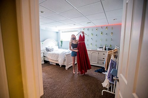 MIKAELA MACKENZIE / WINNIPEG FREE PRESS

Alexa Craig, who is graduating this year, poses for a portrait with her grad dress in her room in Winnipeg on Monday, June 7, 2021. She's one of thousands of Winnipeg grads who said yes to the dress, only for public health to say no to gatherings. For Jen Zoratti story.
Winnipeg Free Press 2021.