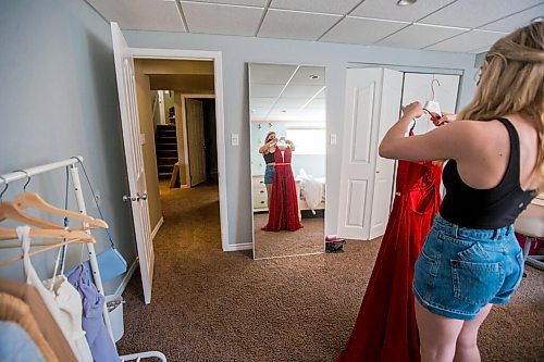 MIKAELA MACKENZIE / WINNIPEG FREE PRESS

Alexa Craig, who is graduating this year, poses for a portrait with her grad dress in her room in Winnipeg on Monday, June 7, 2021. She's one of thousands of Winnipeg grads who said yes to the dress, only for public health to say no to gatherings. For Jen Zoratti story.
Winnipeg Free Press 2021.