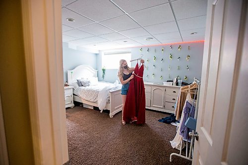 MIKAELA MACKENZIE / WINNIPEG FREE PRESS

Alexa Craig, who is graduating this year, poses for a portrait with her grad dress in her room in Winnipeg on Monday, June 7, 2021. She's one of thousands of Winnipeg grads who said yes to the dress, only for public health to say no to gatherings. For Jen Zoratti story.
Winnipeg Free Press 2021.