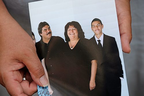 JOHN WOODS / WINNIPEG FREE PRESS
James and Tennis Bullard hold a photo of their sister Kim Bullard with husband Dale and son Dale Jnr. as they mourn the death of Kim Monday, June 7, 2021. Kim Bullard died June 1 of COVID-19 after she was transported out of Manitoba to a hospital in London, On.

Reporter: May