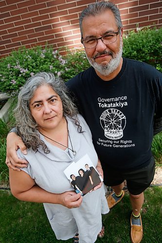 JOHN WOODS / WINNIPEG FREE PRESS
James and Tannis Bullard hold a photo of their sister Kim Bullard with husband Dale and son Dale Jnr. as they mourn the death of Kim Monday, June 7, 2021. Kim Bullard died June 1 of COVID-19 after she was transported out of Manitoba to a hospital in London, On.

Reporter: May