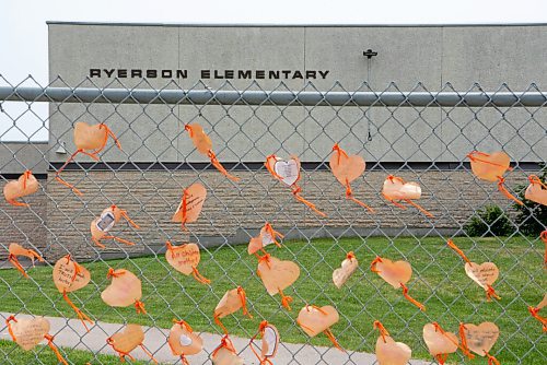 ALEX LUPUL / WINNIPEG FREE PRESS  

Orange hearts tied to the fence outside of  Ryerson School are photographed in Winnipeg on Tuesday, June 8, 2021. The hearts contain messages, written by staff and students, explaining actions they will take to assist the indigenous community. The elementary school is named after Egerton Ryerson, who is considered a chief architect of Canada's residential school system.