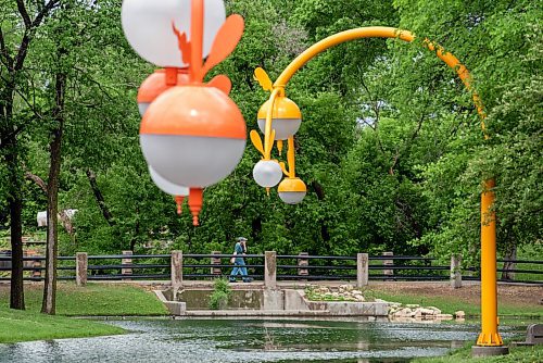 ALEX LUPUL / WINNIPEG FREE PRESS  

People walk along the water at Kildonan Park in Winnipeg on Wednesday, June 9, 2021. Takashi Iwasaki's art, entitled Bokeh, can be seen in the foreground.