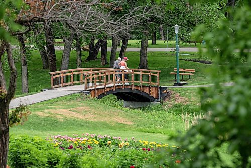 ALEX LUPUL / WINNIPEG FREE PRESS  

People walk over a bridge at Kildonan Park in Winnipeg on Wednesday, June 9, 2021.