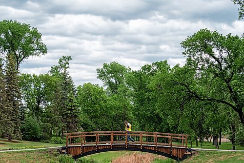 ALEX LUPUL / WINNIPEG FREE PRESS  

A parks employee walks over a bridge at Kildonan Park in Winnipeg on Wednesday, June 9, 2021.