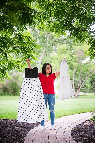 MIKAELA MACKENZIE / WINNIPEG FREE PRESS

SJR student Lauren McIlroy poses for a portrait holding the two dresses that she was excited to wear to grad events that have been cancelled at her home in La Salle on Thursday, June 10, 2021. For Jen story.
Winnipeg Free Press 2021.