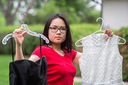 MIKAELA MACKENZIE / WINNIPEG FREE PRESS

SJR student Lauren McIlroy poses for a portrait holding the two dresses that she was excited to wear to grad events that have been cancelled at her home in La Salle on Thursday, June 10, 2021. For Jen story.
Winnipeg Free Press 2021.