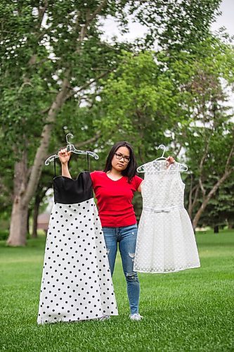 MIKAELA MACKENZIE / WINNIPEG FREE PRESS

SJR student Lauren McIlroy poses for a portrait holding the two dresses that she was excited to wear to grad events that have been cancelled at her home in La Salle on Thursday, June 10, 2021. For Jen story.
Winnipeg Free Press 2021.