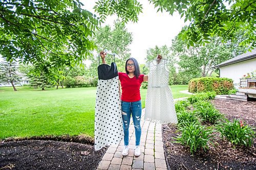 MIKAELA MACKENZIE / WINNIPEG FREE PRESS

SJR student Lauren McIlroy poses for a portrait holding the two dresses that she was excited to wear to grad events that have been cancelled at her home in La Salle on Thursday, June 10, 2021. For Jen story.
Winnipeg Free Press 2021.