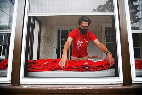 JOHN WOODS / WINNIPEG FREE PRESS
Aaron Beckman, a Winnipeg resource teacher and member of Protect EdMB, organizes and distributes red t-shirts in his sunroom Thursday, June 10, 2021. Beckman oversees the Protect EdMB Red For Ed t-shirt campaign which speaks out about the provincial governments Bill 64, which overhauls K-12 education, and also raises money for school breakfast and lunch programs.

Reporter: Macintosh
