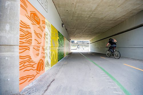 MIKAELA MACKENZIE / WINNIPEG FREE PRESS

Cyclists pass by a new mural by Natalie Baird at the Jubilee overpass bike route, which was painted as part of the Wheels of Courage volunteer program, in Winnipeg on Friday, June 11, 2021. Bike to Art day, where folks are encouraged to bike to public art displays as part of bike week, is on Saturday June 12. Standup.
Winnipeg Free Press 2021.