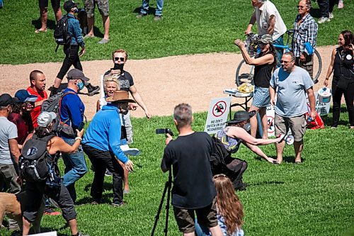Daniel Crump / Winnipeg Free Press. A counter protestor falls to the ground after being shoved from behind. The counter protestors were asked to leave when they began making noise and throwing glitter and water at people. June 12, 2021.