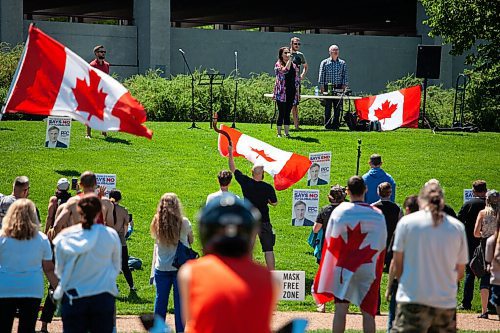 Daniel Crump / Winnipeg Free Press. Canada flags and campaign signs for Maxime Bernier are a prominent feature during an anti-restrictions rally at the Forks on Saturday afternoon. June 12, 2021.