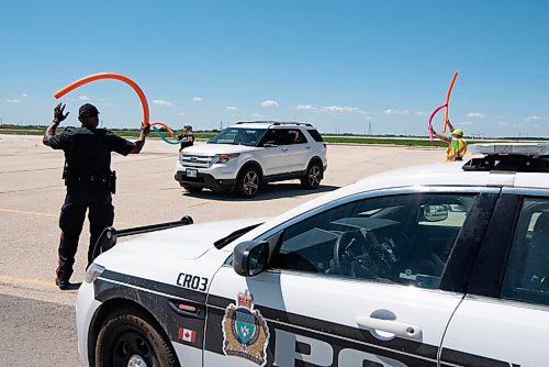 ALEX LUPUL / WINNIPEG FREE PRESS  

The Winnipeg Police Service welcomes  attendees to the Winnipeg International Children's Festival at the Red River Exhibition Park on Sunday, June 13, 2021. Due to ongoing restrictions, the format has shifted to a drive-in format.