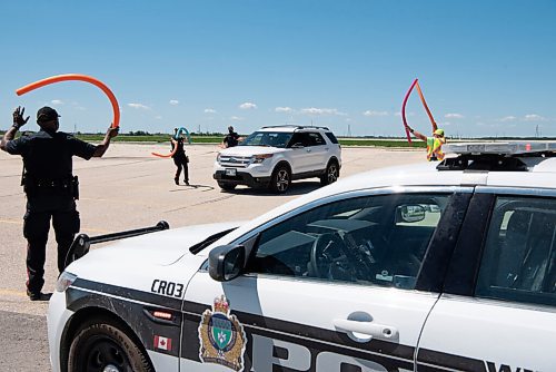 ALEX LUPUL / WINNIPEG FREE PRESS  

The Winnipeg Police Service welcomes  attendees to the Winnipeg International Children's Festival at the Red River Exhibition Park on Sunday, June 13, 2021. Due to ongoing restrictions, the format has shifted to a drive-in format.