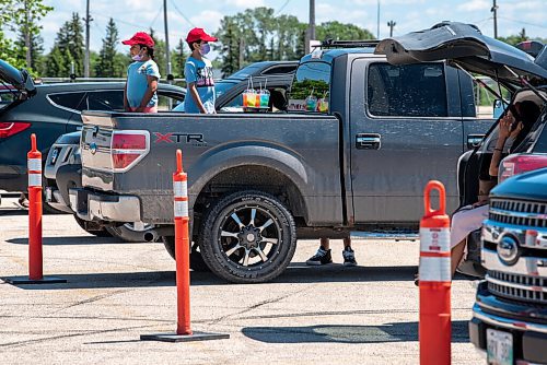 ALEX LUPUL / WINNIPEG FREE PRESS  

Attendees enjoy the Winnipeg International Children's Festival from the comfort of their vehicles at the Red River Exhibition Park on Sunday, June 13, 2021. Due to ongoing restrictions, the format has shifted to a drive-in format.