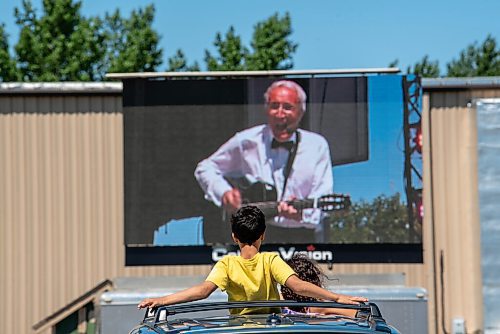 ALEX LUPUL / WINNIPEG FREE PRESS  

Children watch Al Simmons perform at the Winnipeg International Children's Festival at the Red River Exhibition Park on Sunday, June 13, 2021. Due to ongoing restrictions, the format has shifted to a drive-in format.