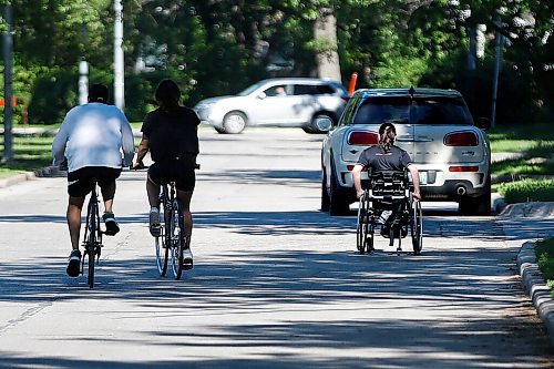 JOHN WOODS / WINNIPEG FREE PRESS
A person in a wheelchair makes their way down Wellington Crescent Tuesday, June 15, 2021. Sarah Manteuffel, who has dwarfism and identifies as disabled, finds it easier to bike on the open street as a person with a disability. Some residents are complaining that the program is leading to more traffic on Academy Road and prompting confrontations between drivers and pedestrians.

Reporter: Rutgers
