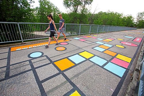 MIKE DEAL / WINNIPEG FREE PRESS
Five pedestrian bridges look a lot brighter this week thanks to a fresh coat of paint and creativity.
Four bridges spanning the Seine River and one spanning Bunns Creek are being treated to a makeover courtesy of Cool Streets Winnipeg, along with a talented roster of local artists. Theres citrus fruit, hopscotch, seals slapping around in the water, graffiti, and more.
The John Bruce Road Bridge, just off St. Annes in St. Vital is almost finished being painted. The crew stopped because of the rain. 
See Ben Waldman story
210616 - Wednesday, June 16, 2021.