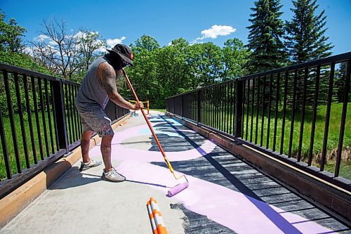 MIKE DEAL / WINNIPEG FREE PRESS
Artist Pat Lazo paints on a footbridge in Bunn's Creek Centennial Park Thursday morning as one of Cool Streets Winnipeg artists. 
Five pedestrian bridges look a lot brighter this week thanks to a fresh coat of paint and creativity.
Four bridges spanning the Seine River and one spanning Bunns Creek are being treated to a makeover courtesy of Cool Streets Winnipeg, along with a talented roster of local artists. Theres citrus fruit, hopscotch, seals slapping around in the water, graffiti, and more.
See Ben Waldman story
210617 - Thursday, June 17, 2021.