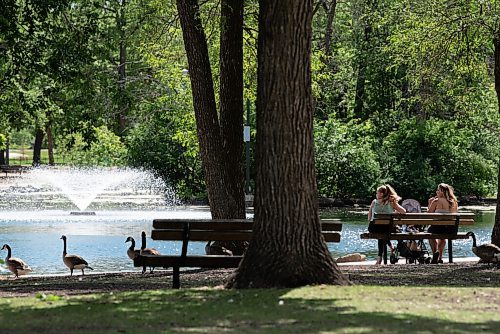ALEX LUPUL / WINNIPEG FREE PRESS  

Visitors to St. Vital Park look out at the duck pond's fountain on Thursday, June 17, 2021.