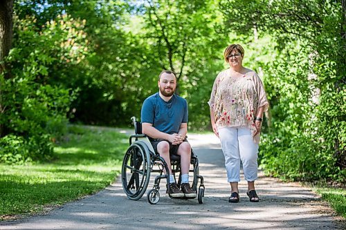 MIKAELA MACKENZIE / WINNIPEG FREE PRESS

Christine Schollenberg, outgoing executive director of the Childrens Rehabilitation Foundation, and Andrew Fenwick pose for a portrait in Munson Park in Winnipeg on Thursday, June 17, 2021. For --- story.
Winnipeg Free Press 2021.