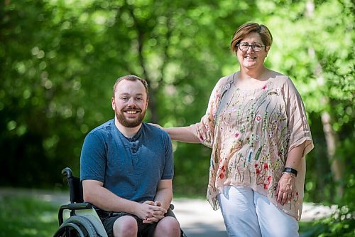 MIKAELA MACKENZIE / WINNIPEG FREE PRESS

Christine Schollenberg, outgoing executive director of the Childrens Rehabilitation Foundation, and Andrew Fenwick pose for a portrait in Munson Park in Winnipeg on Thursday, June 17, 2021. For --- story.
Winnipeg Free Press 2021.