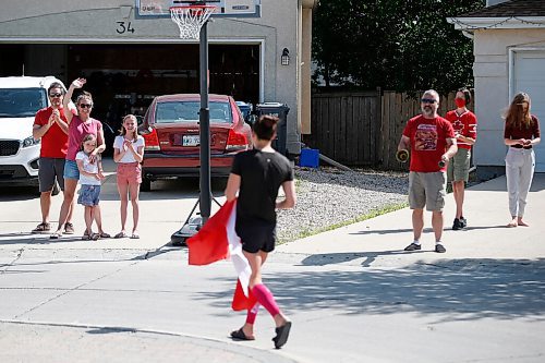 JOHN WOODS / WINNIPEG FREE PRESS
Winnipeg swimmer Kelsey Wog is greeted by her neighbours Thursday, June 17, 2021. Residents of Wogs street gathered at the end of their driveways to wish her well as she heads off to the national swimming trials. 

Reporter: Sawatzki